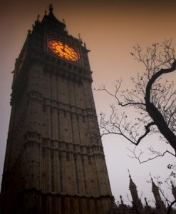 The spooky clock tower of Westminster with bare tree in autumn